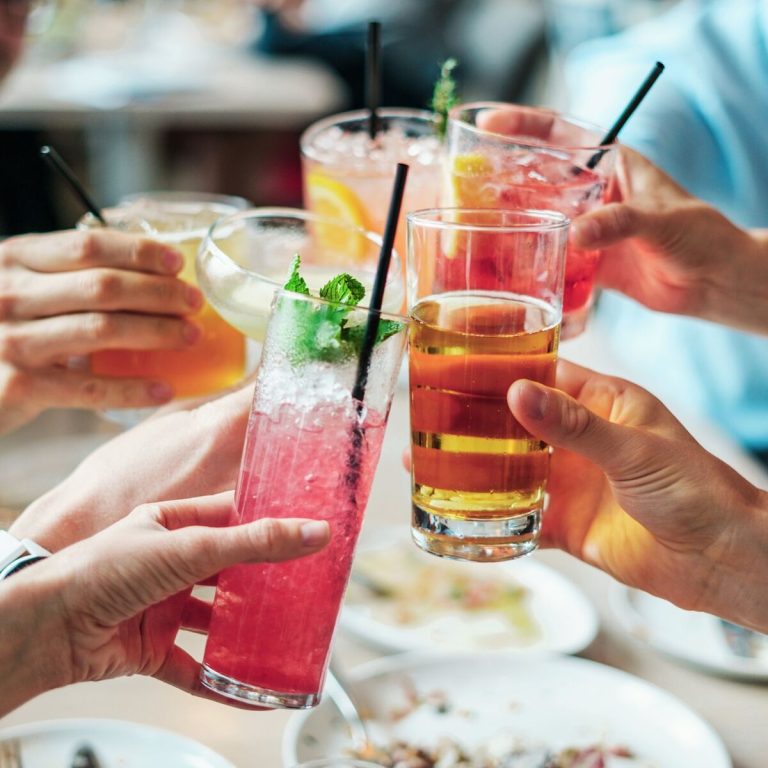 A group of people toasting drinks at a restaurant.