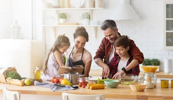 A family is preparing food in the kitchen.