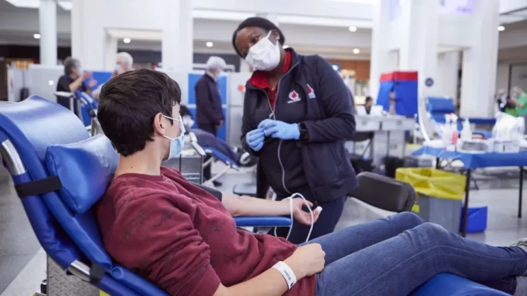 A man is getting a blood transfusion in a hospital.