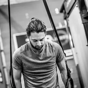 Black and white photo of a man in a gym.