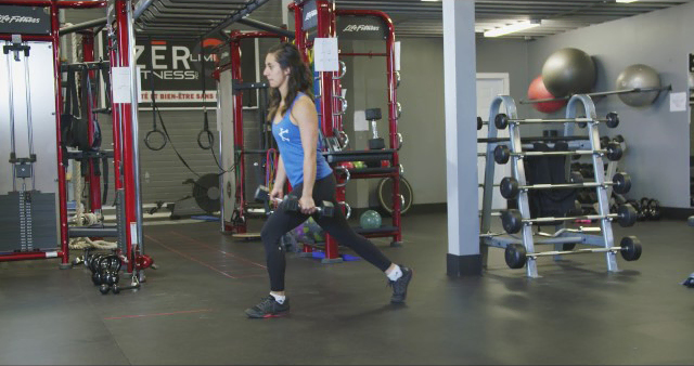 A woman is working out in a gym.